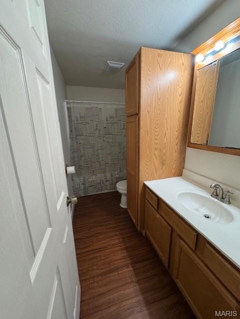 1804 N Oak St, Rolla, MO 65401 - bathroom with vanity, toilet, wood finished floors, and a shower