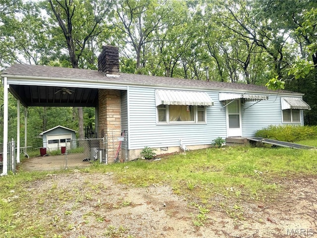 55 Indian Hills Dr, Cuba, MO 65453 - view of front of property with a chimney, an outbuilding, and roof with shingles