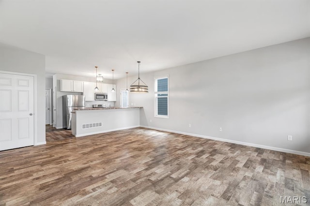 109 Starry Night Way, Saint Charles, MO 63301 - kitchen featuring stainless steel appliances, white cabinets, wood finished floors, and open floor plan