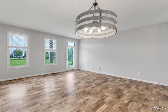 109 Starry Night Way, Saint Charles, MO 63301 - empty room with wood finished floors and a chandelier