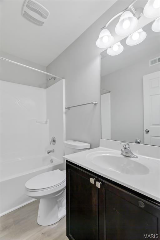 109 Starry Night Way, Saint Charles, MO 63301 - bathroom with vanity, wood finished floors, and  shower combination