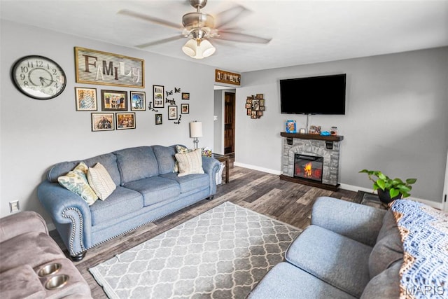 415 Virginia Ave, Cottage Hills, IL 62018 - living area with ceiling fan, baseboards, wood finished floors, and a stone fireplace