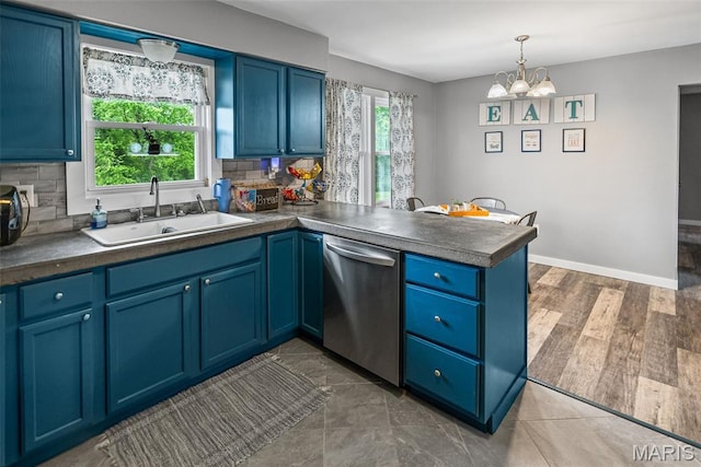 415 Virginia Ave, Cottage Hills, IL 62018 - kitchen featuring stainless steel dishwasher, a sink, a peninsula, a chandelier, and tasteful backsplash