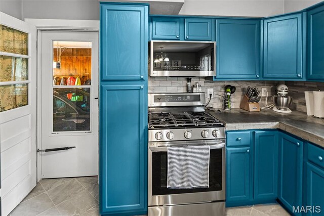 415 Virginia Ave, Cottage Hills, IL 62018 - kitchen featuring appliances with stainless steel finishes, blue cabinetry, and dark countertops