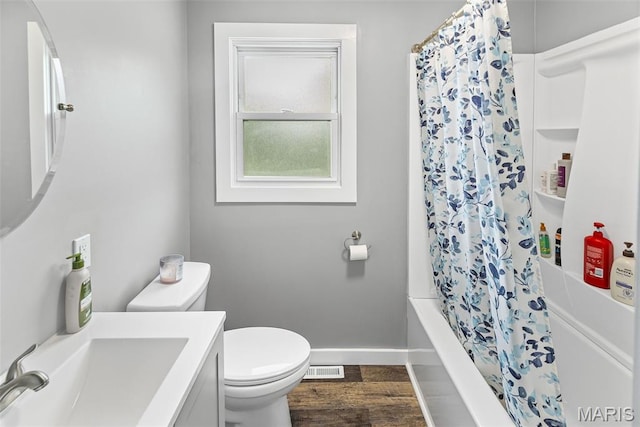 415 Virginia Ave, Cottage Hills, IL 62018 - bathroom featuring toilet, vanity, shower / tub combo with curtain, baseboards, and wood finished floors
