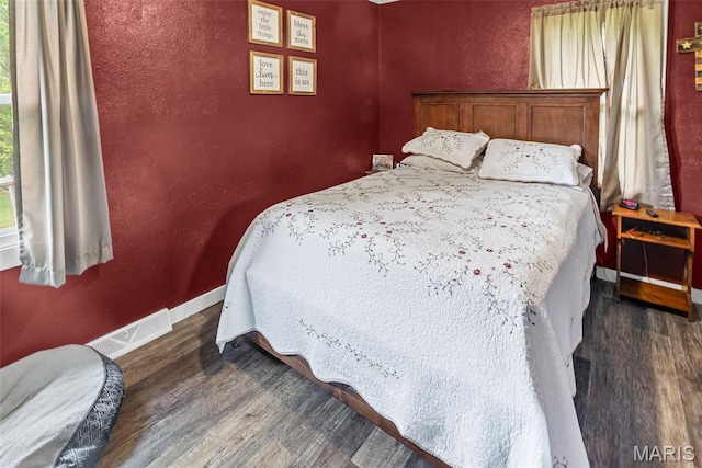 415 Virginia Ave, Cottage Hills, IL 62018 - bedroom featuring dark wood finished floors, baseboards, and a textured wall