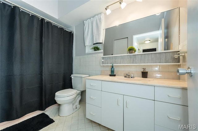 110 Coral Ter Unit 13, Ballwin, MO 63011 - bathroom with toilet, tile patterned flooring, vanity, tile walls, and a wainscoted wall