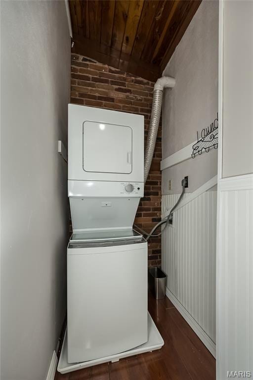 110 Coral Ter Unit 13, Ballwin, MO 63011 - washroom featuring brick wall, stacked washer and clothes dryer, wooden ceiling, and dark wood-style floors