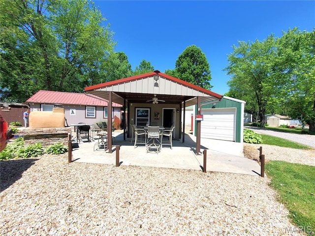 303 Arrowhead Trl, Hermann, MO 65041 - back of property with a ceiling fan, an outdoor structure, and a patio area