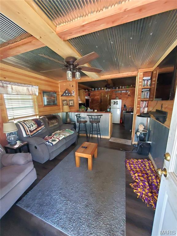 303 Arrowhead Trl, Hermann, MO 65041 - living room with a ceiling fan, wood walls, and wood finished floors