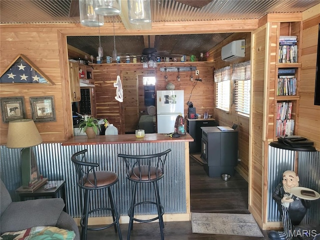 303 Arrowhead Trl, Hermann, MO 65041 - indoor dry bar with freestanding refrigerator, wood walls, a wall mounted air conditioner, and wood finished floors