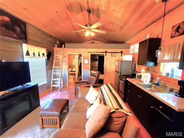 303 Arrowhead Trl, Hermann, MO 65041 - living area featuring wood walls, vaulted ceiling, ceiling fan, wooden ceiling, and a barn door