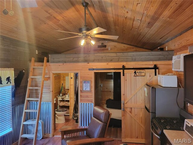 303 Arrowhead Trl, Hermann, MO 65041 - bedroom with a barn door, vaulted ceiling, wooden walls, wood finished floors, and wood ceiling