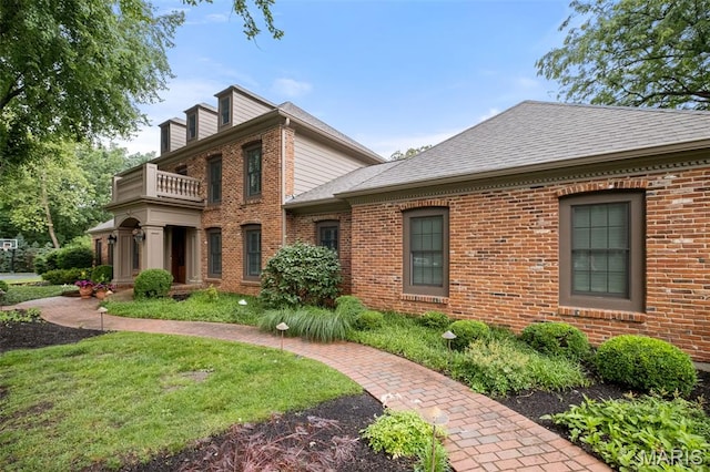 9 Arlington Oaks Ct, Town And Country, MO 63017 - colonial house featuring a balcony, brick siding, a shingled roof, and a front yard