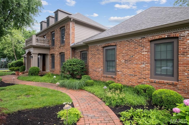 9 Arlington Oaks Ct, Town And Country, MO 63017 - view of home's exterior featuring a balcony, brick siding, a shingled roof, and a chimney