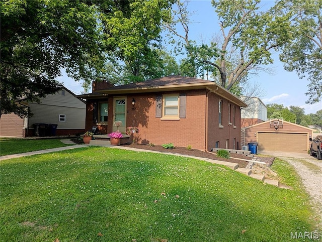 604 N Hena St, Greenville, IL 62246 - bungalow-style home with brick siding, a front yard, a detached garage, and an outbuilding