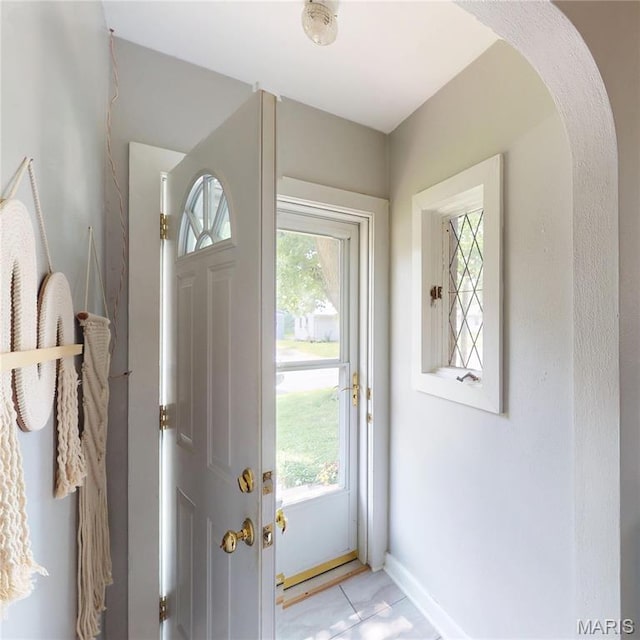 604 N Hena St, Greenville, IL 62246 - foyer featuring plenty of natural light, arched walkways, baseboards, and light tile patterned floors