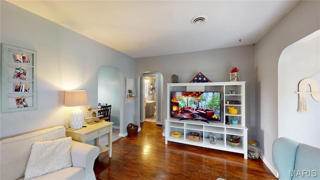 604 N Hena St, Greenville, IL 62246 - living area featuring arched walkways, wood finished floors, and baseboards