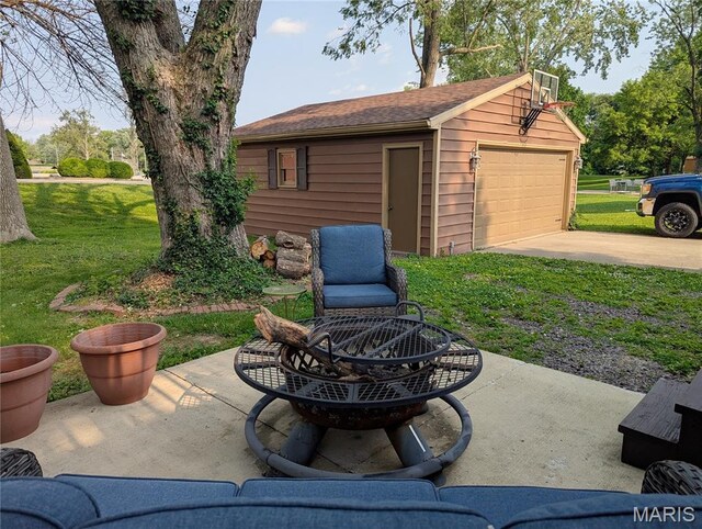 604 N Hena St, Greenville, IL 62246 - view of patio featuring a fire pit, an outbuilding, and a detached garage