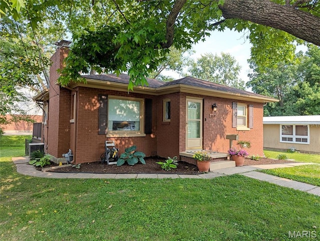 604 N Hena St, Greenville, IL 62246 - ranch-style home featuring a chimney, brick siding, a front yard, central air condition unit, and roof with shingles