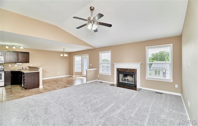 628 Meadowgreen Dr, Troy, MO 63379 - unfurnished living room with healthy amount of natural light, light colored carpet, lofted ceiling, a premium fireplace, and light tile patterned floors