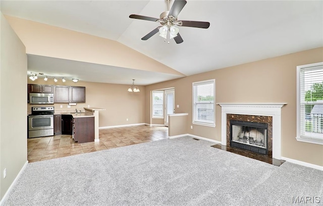628 Meadowgreen Dr, Troy, MO 63379 - unfurnished living room with light carpet, a premium fireplace, plenty of natural light, light tile patterned floors, and vaulted ceiling