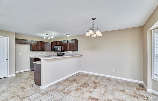 628 Meadowgreen Dr, Troy, MO 63379 - kitchen with stainless steel microwave, light countertops, dark brown cabinetry, a chandelier, and a peninsula