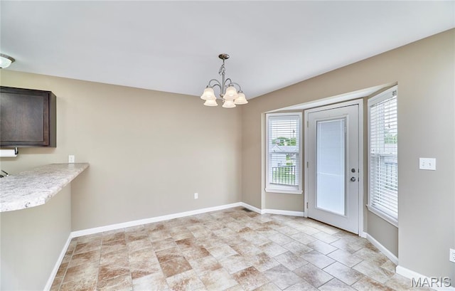 628 Meadowgreen Dr, Troy, MO 63379 - unfurnished dining area featuring stone finish floors and a chandelier