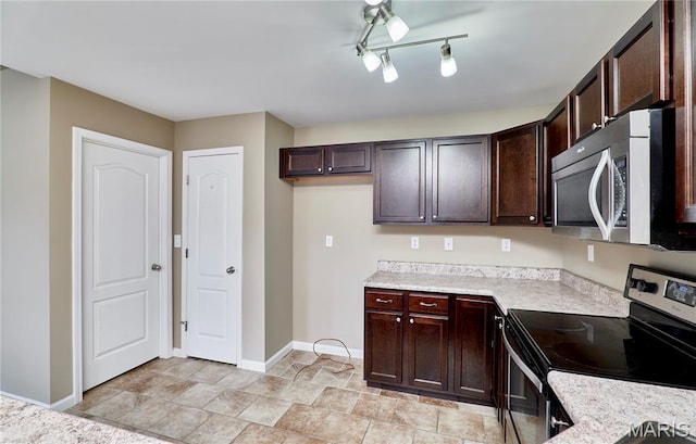628 Meadowgreen Dr, Troy, MO 63379 - kitchen featuring appliances with stainless steel finishes, light countertops, dark brown cabinets, and light stone finish flooring