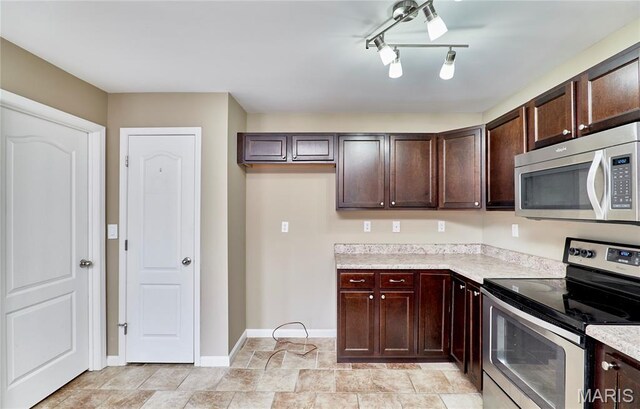 628 Meadowgreen Dr, Troy, MO 63379 - kitchen featuring stainless steel appliances, light countertops, and dark brown cabinets