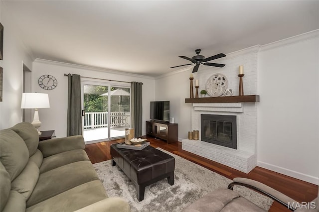 3644 Cinnamon Tree Ln, Oakville, MO 63129 - living area with crown molding, wood finished floors, ceiling fan, and a fireplace