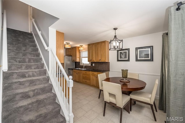 3644 Cinnamon Tree Ln, Oakville, MO 63129 - dining area featuring stairs, a chandelier, and light tile patterned flooring