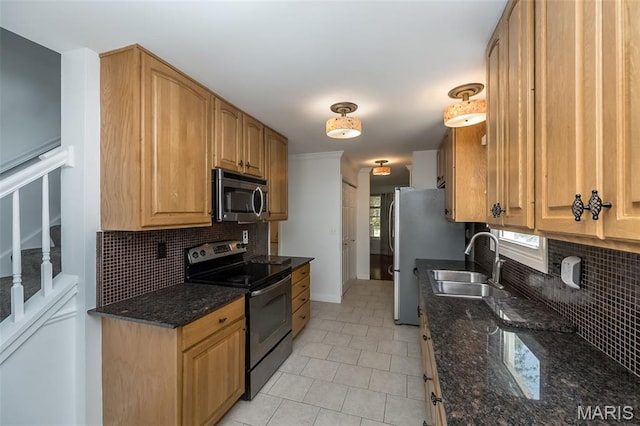 3644 Cinnamon Tree Ln, Oakville, MO 63129 - kitchen featuring appliances with stainless steel finishes, tasteful backsplash, light tile patterned flooring, and dark stone counters