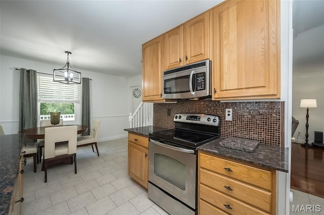 3644 Cinnamon Tree Ln, Oakville, MO 63129 - kitchen with appliances with stainless steel finishes, a chandelier, decorative backsplash, dark stone counters, and light tile patterned flooring