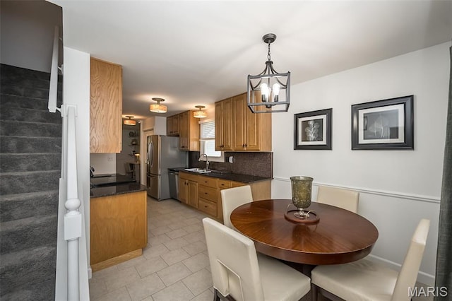 3644 Cinnamon Tree Ln, Oakville, MO 63129 - dining space with light tile patterned floors and a chandelier