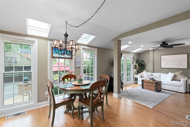 9351 White Ave, Brentwood, MO 63144 - dining space with a skylight, a chandelier, light wood-type flooring, lofted ceiling, and baseboards