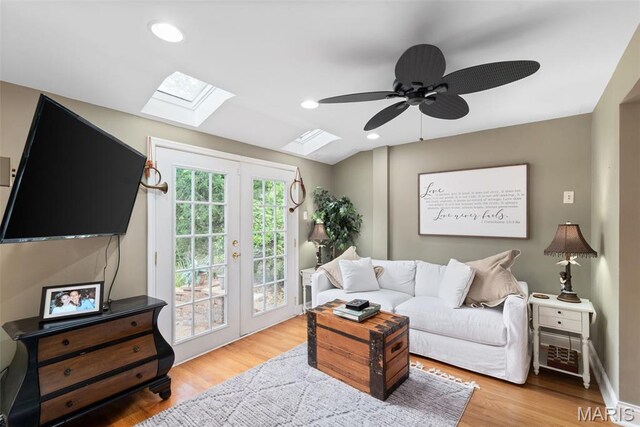 9351 White Ave, Brentwood, MO 63144 - living room featuring a skylight, french doors, ceiling fan, light wood-style floors, and recessed lighting