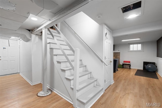 9351 White Ave, Brentwood, MO 63144 - basement featuring light wood-style floors, stairs, and baseboards