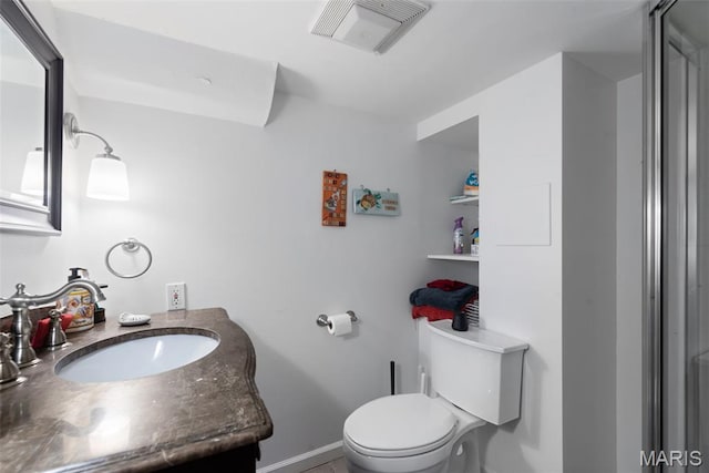9351 White Ave, Brentwood, MO 63144 - bathroom featuring toilet, vanity, and baseboards