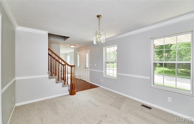 1583 Clarys Grv, Ofallon, IL 62269 - empty room featuring stairway, crown molding, carpet, baseboards, and a textured ceiling