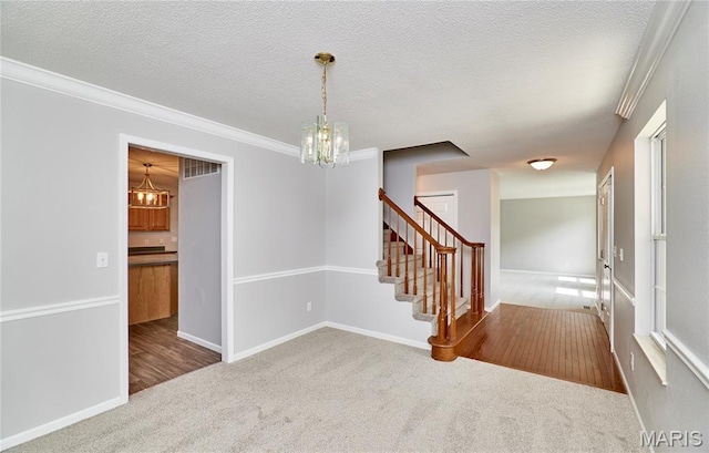 1583 Clarys Grv, Ofallon, IL 62269 - empty room featuring a chandelier, carpet flooring, crown molding, stairs, and baseboards