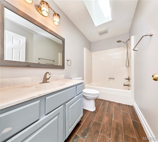 1583 Clarys Grv, Ofallon, IL 62269 - bathroom featuring toilet, vanity, wood finished floors, tub / shower combination, and a skylight