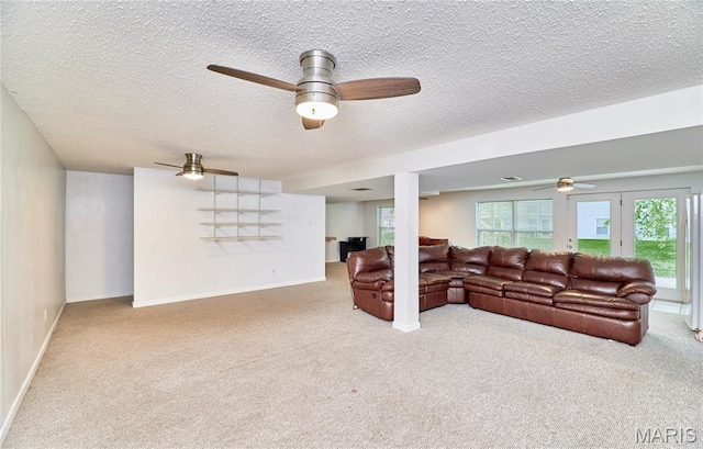 1583 Clarys Grv, Ofallon, IL 62269 - carpeted living area featuring a ceiling fan, a textured ceiling, healthy amount of natural light, and baseboards