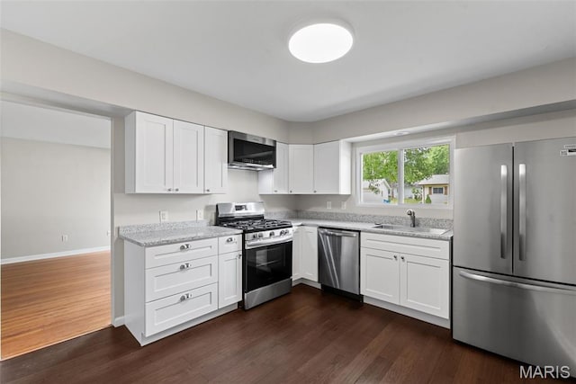 6714 Sandy Hill Dr, Hazelwood, MO 63042 - kitchen with appliances with stainless steel finishes, a sink, dark wood-style floors, light stone countertops, and white cabinets