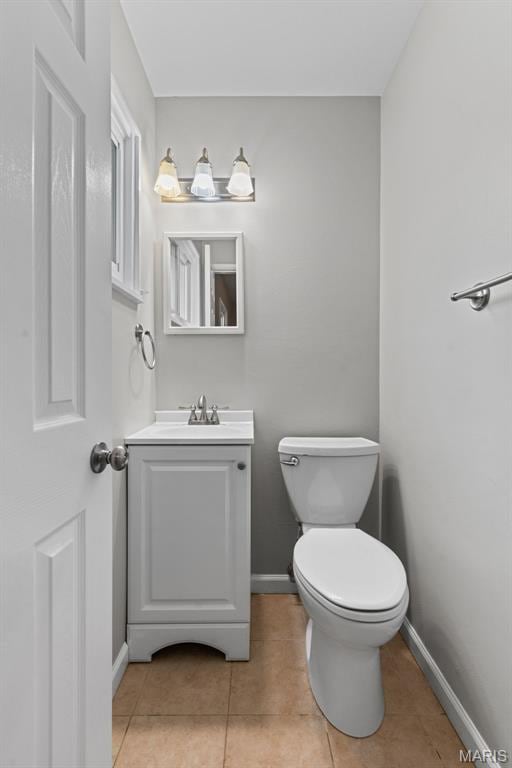 6714 Sandy Hill Dr, Hazelwood, MO 63042 - half bathroom featuring vanity, toilet, tile patterned floors, and baseboards