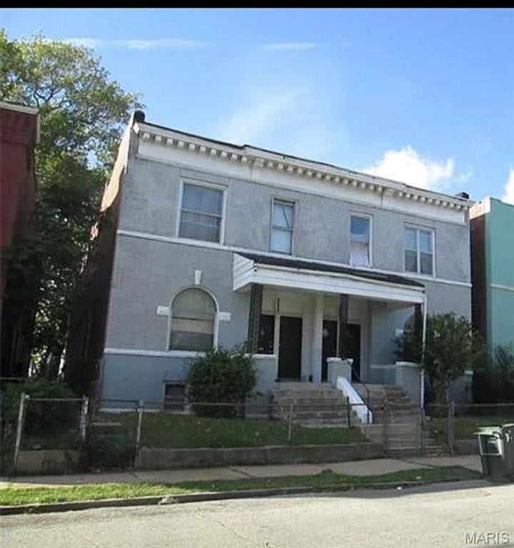 1519 Arlington Ave, Saint Louis, MO 63112 - italianate-style house featuring a fenced front yard and stucco siding