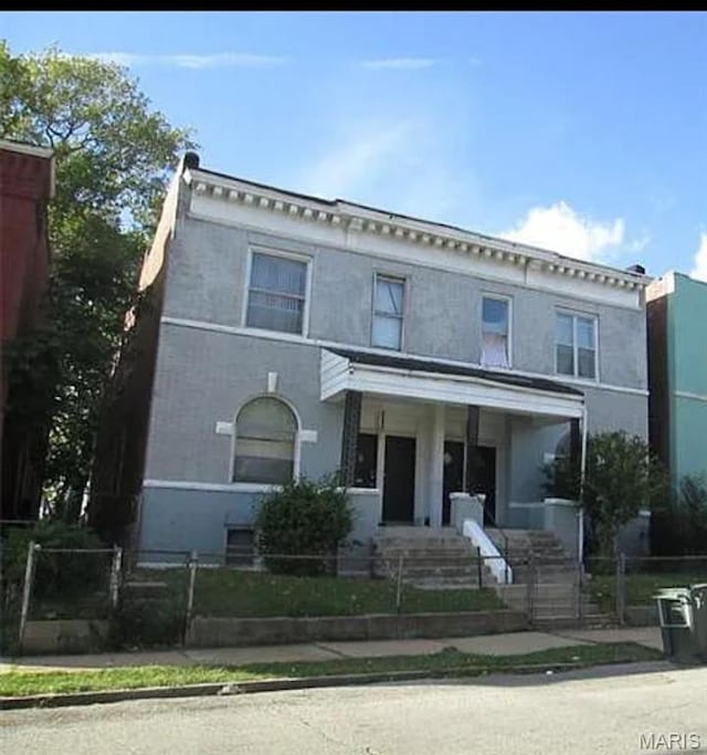 1519 Arlington Ave, Saint Louis, MO 63112 - italianate-style house featuring a fenced front yard and stucco siding