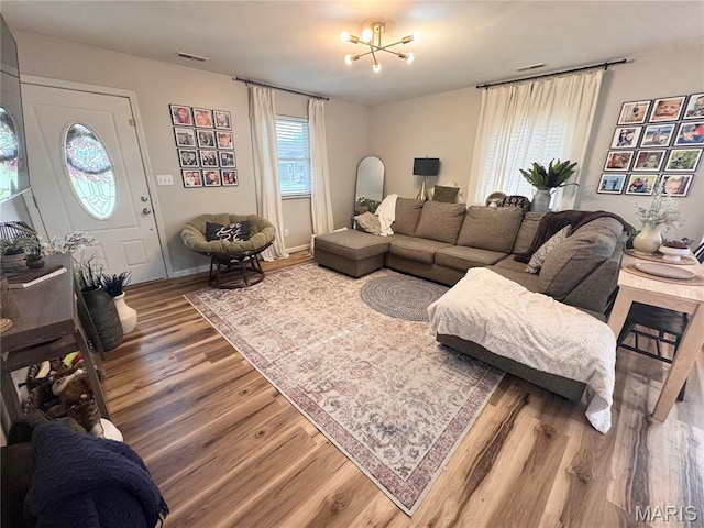 1319 W Church St, Bowling Green, MO 63334 - living room featuring wood finished floors, a chandelier, and baseboards