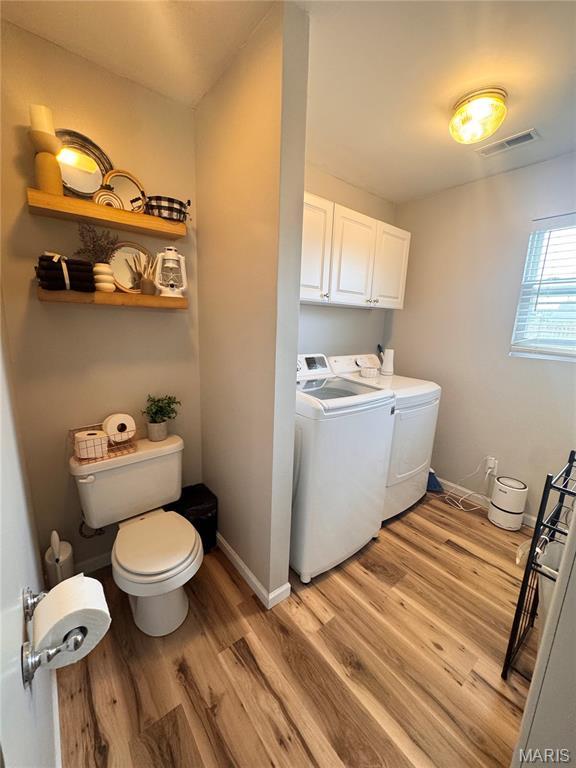 1319 W Church St, Bowling Green, MO 63334 - laundry area with separate washer and dryer, light wood-style flooring, and baseboards