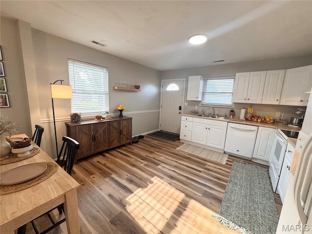 1319 W Church St, Bowling Green, MO 63334 - kitchen with white appliances, a sink, white cabinetry, light wood finished floors, and light countertops